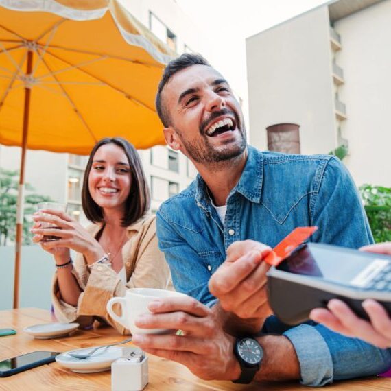 Happy,Young,Adult,Man,Paying,The,Bill,With,A,Contactless
