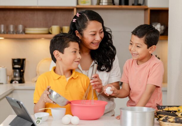 Mom,With,Her,Hispanic,Children,Preparing,A,Cake,At,Home