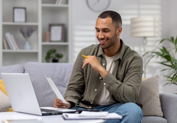 Young,Successful,Hispanic,Man,At,Home,Sitting,On,Sofa,In