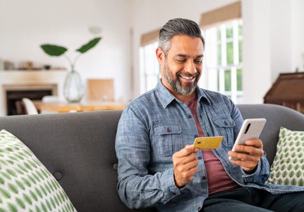 Middle,Eastern,Mature,Man,Using,Credit,Card,To,Make,Online