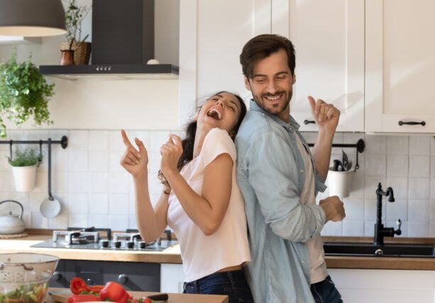 Overjoyed,Young,Family,Having,Fun,In,Modern,Kitchen,,Dancing,And