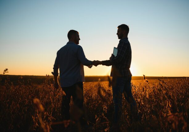 Two,Farmers,Shaking,Hands,In,Soybean,Field
