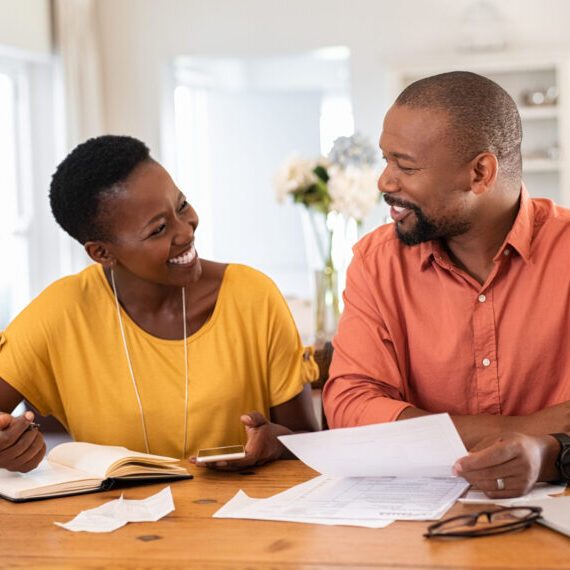 Mature,Couple,Sitting,And,Managing,Expenses,At,Home.,Happy,African