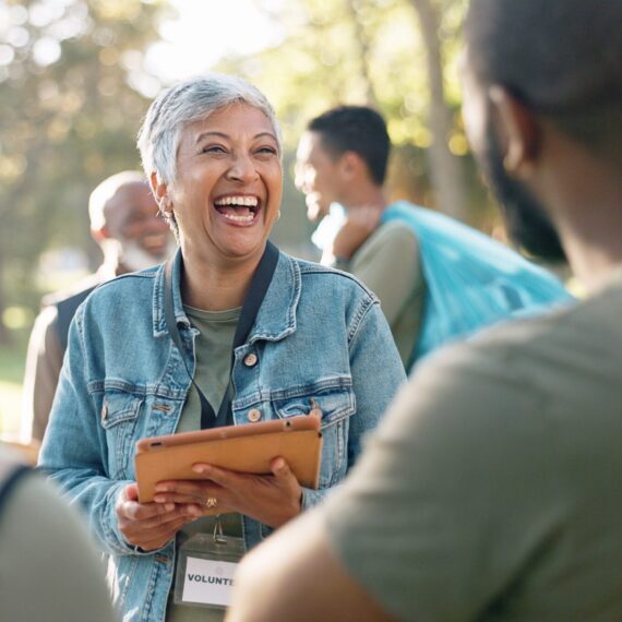 Park,,Woman,And,Laugh,Planning,With,Tablet,For,Volunteer,Teamwork,